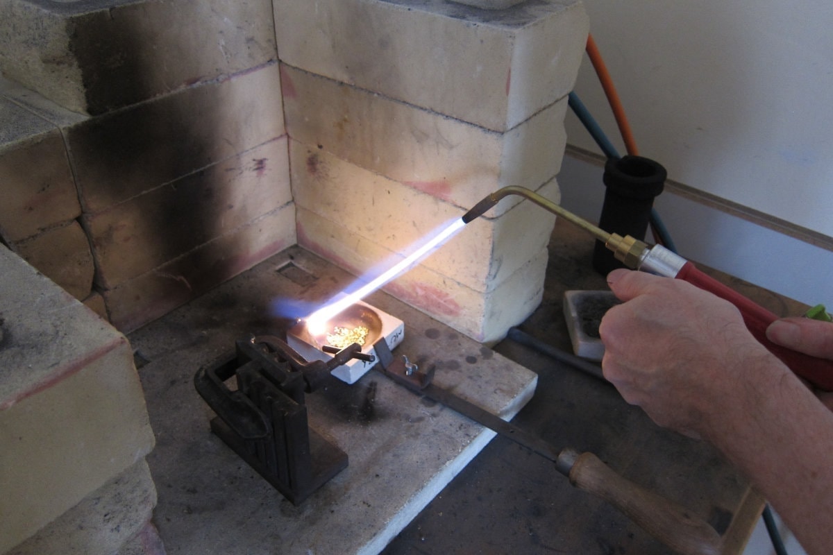 Torch using gas and air mix to melt the grains in the crucible.